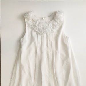 White dress with white flowers on front. Mid cut.